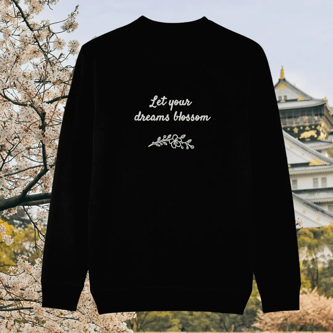 Back of the black organic cotton sweater with the quote “Let Your Dreams Blossom” in a floral blossom design – Mindful Earth UK sustainable fashion
