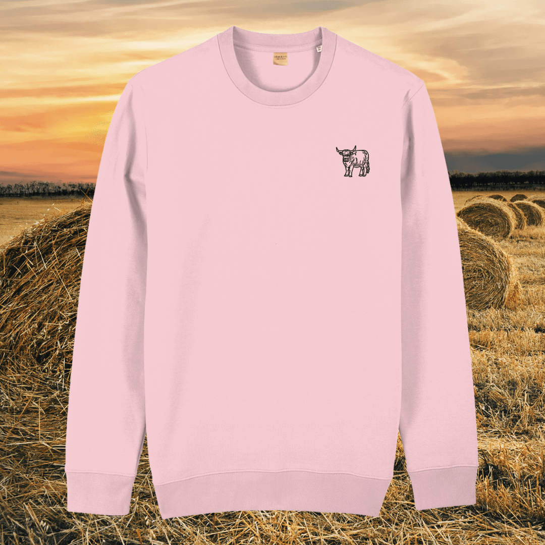 Front view of the Highland Cow Cotton Pink organic cotton sweater featuring the “Live Like Someone Left the Gate Open” design by Mindful Earth.