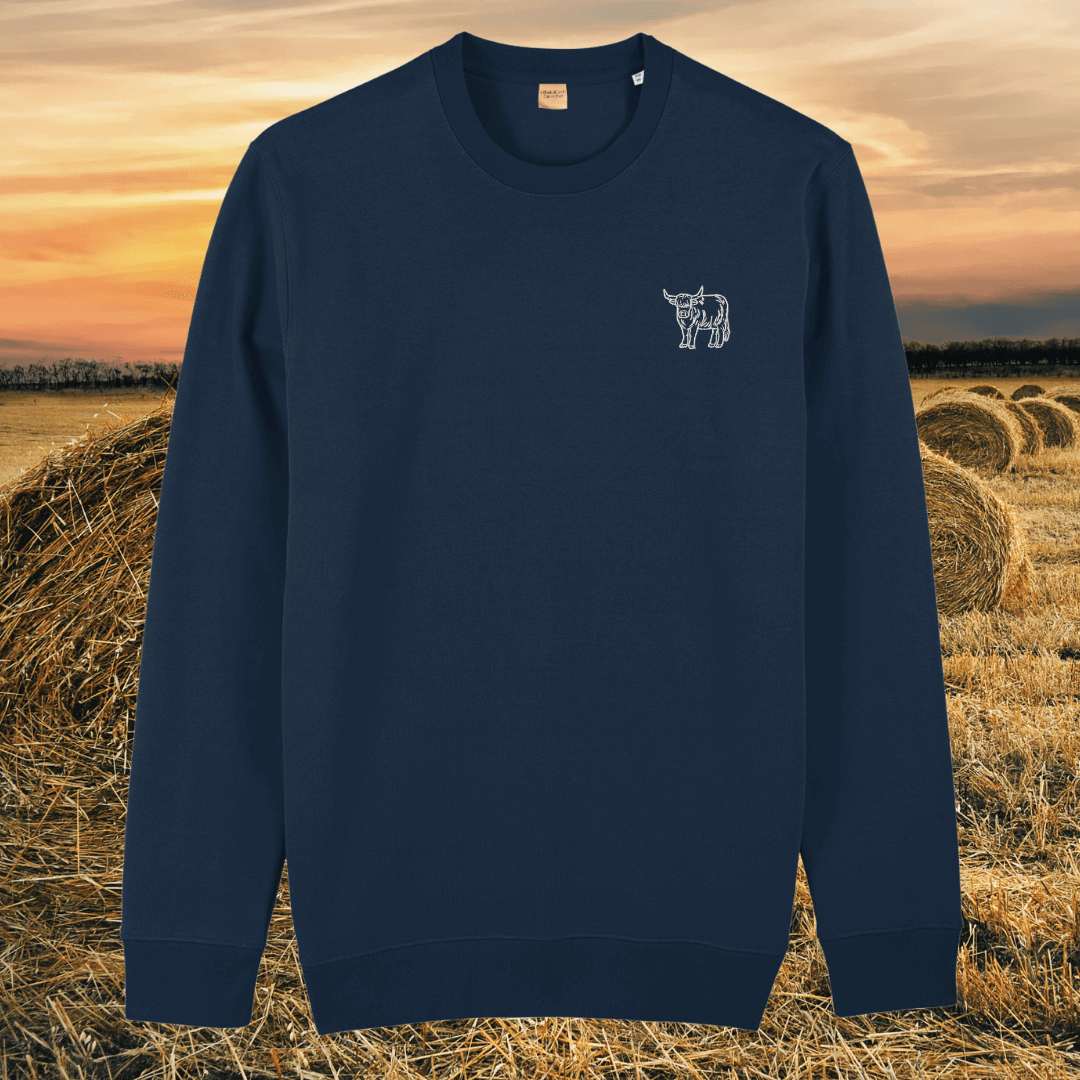 Front view of the Highland Cow French Navy organic cotton sweater featuring the “Live Like Someone Left the Gate Open” design by Mindful Earth.