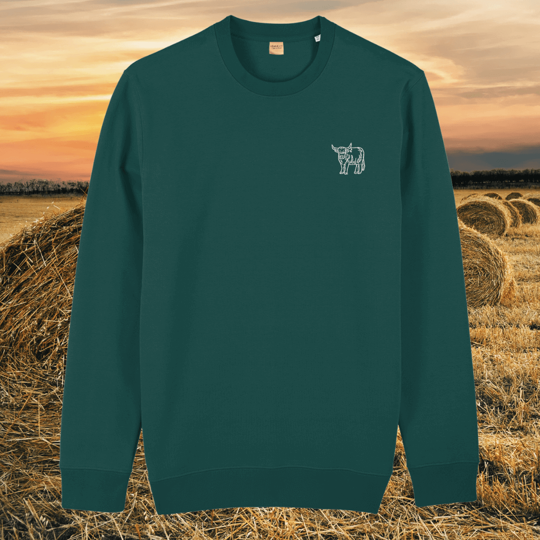 Front view of the Highland Cow Glazed Green organic cotton sweater featuring the “Live Like Someone Left the Gate Open” design by Mindful Earth.
