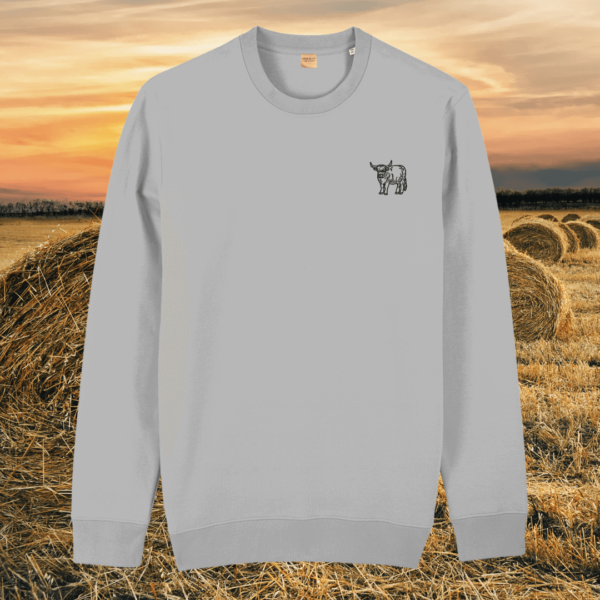 Front view of the Highland Cow Heather Grey organic cotton sweater featuring the “Live Like Someone Left the Gate Open” design by Mindful Earth.