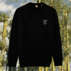 Front view of the Koala Black organic cotton sweater featuring the “Create Your Happy Place” design by Mindful Earth.