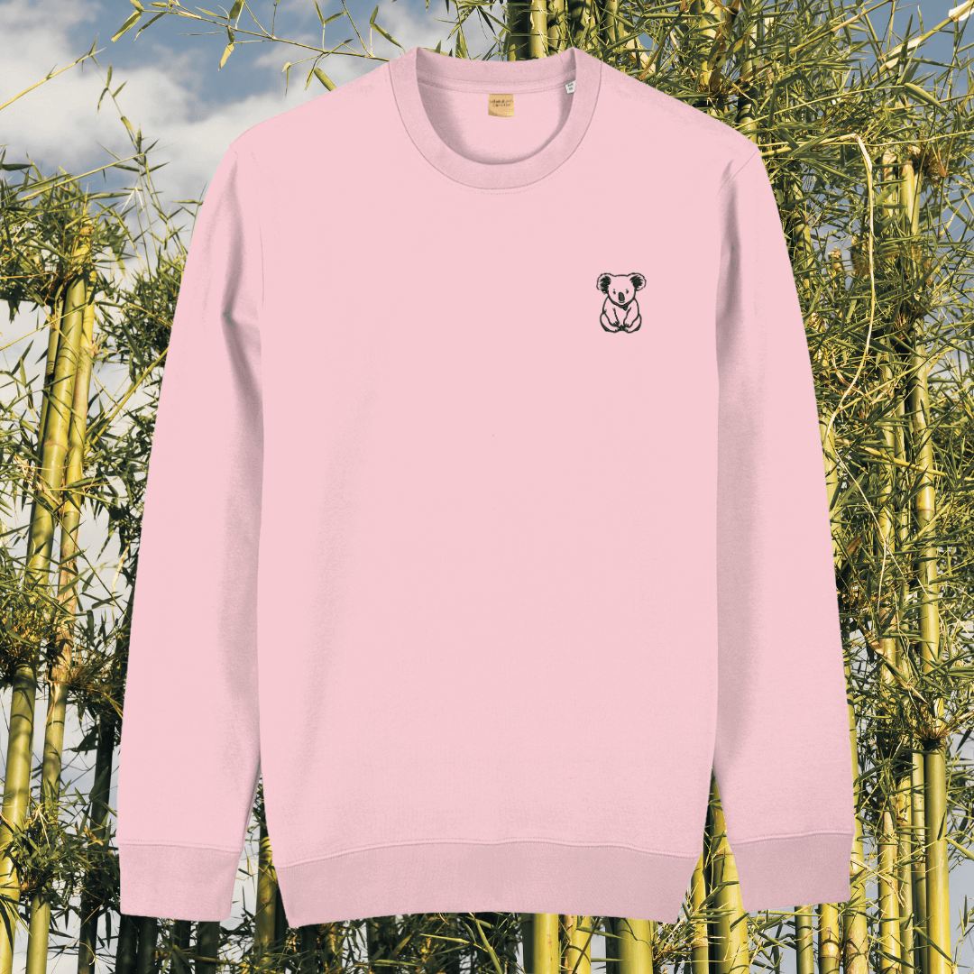 Front view of the Koala Cotton Pink organic cotton sweater featuring the “Create Your Happy Place” design by Mindful Earth.