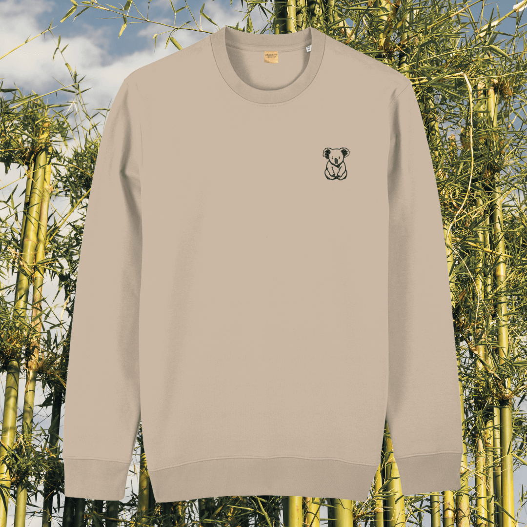 Front view of the Koala Desert Dust organic cotton sweater featuring the “Create Your Happy Place” design by Mindful Earth.