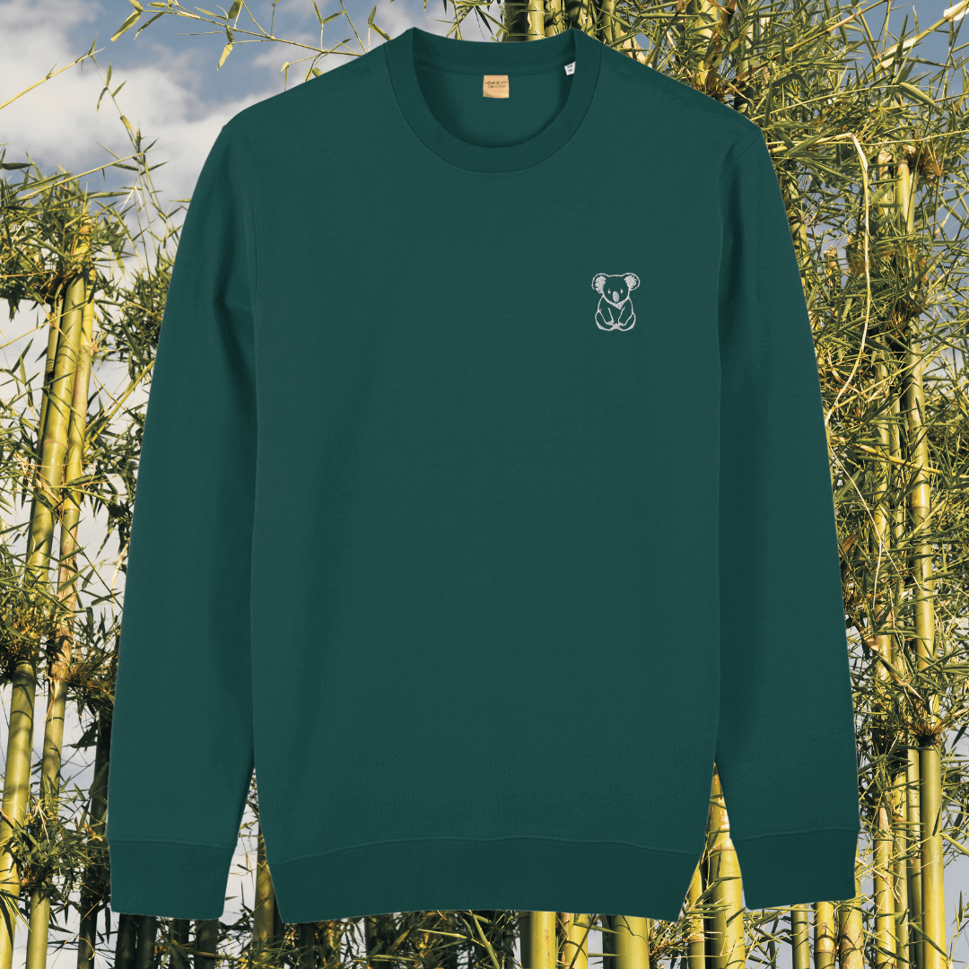 Front view of the Koala Glazed Green organic cotton sweater featuring the “Create Your Happy Place” design by Mindful Earth.