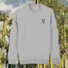 Front view of the Koala Heather Grey organic cotton sweater featuring the “Create Your Happy Place” design by Mindful Earth.