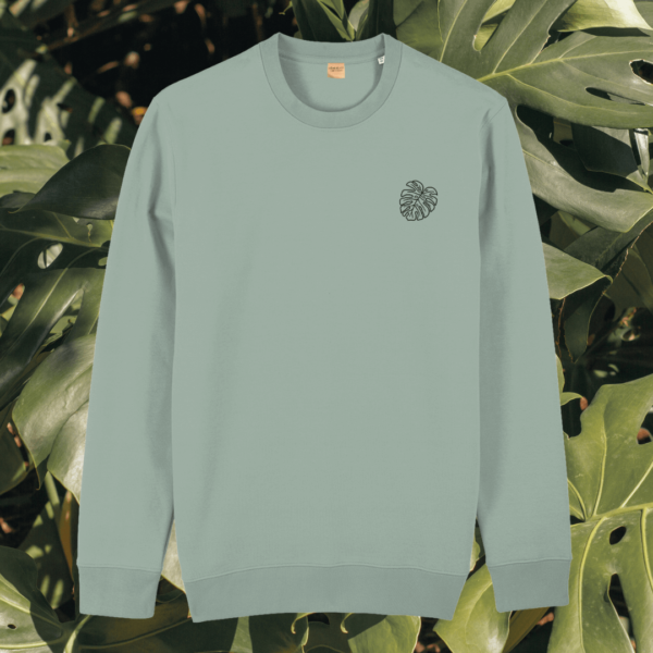 Front view of the Monstera Aloe organic cotton sweater featuring the “Life’s a Climb but the View is Great” design by Mindful Earth.