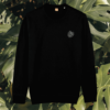 Front view of the Monstera Black organic cotton sweater featuring the “Life’s a Climb but the View is Great” design by Mindful Earth.