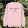 Back view of the Monstera Cotton Pink organic cotton sweater with the “Life’s a Climb but the View is Great” print by Mindful Earth.