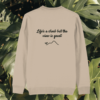 Back view of the Monstera Desert Dust organic cotton sweater with the “Life’s a Climb but the View is Great” print by Mindful Earth.