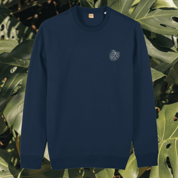 Front view of the Monstera French Navy organic cotton sweater featuring the “Life’s a Climb but the View is Great” design by Mindful Earth.