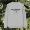 Back view of the Monstera Heather Grey organic cotton sweater with the “Life’s a Climb but the View is Great” print by Mindful Earth.