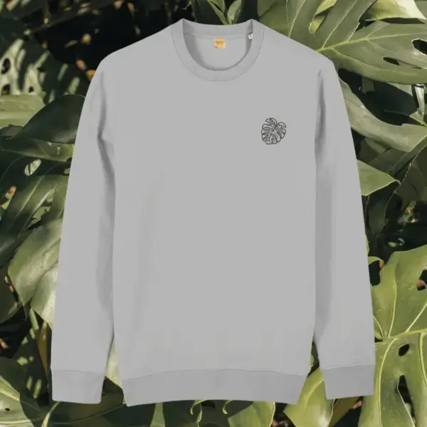 Front view of the Monstera Heather Grey organic cotton sweater featuring the “Life’s a Climb but the View is Great” design by Mindful Earth.