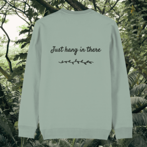 Back of the Aloe Green organic cotton sweater featuring sloth illustration and the phrase “Just Hang In There” – Mindful Earth UK sustainable fashion