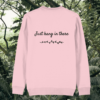 Back of the Cotton Pink organic cotton sweater featuring sloth illustration and the phrase “Just Hang In There” – Mindful Earth UK sustainable fashion