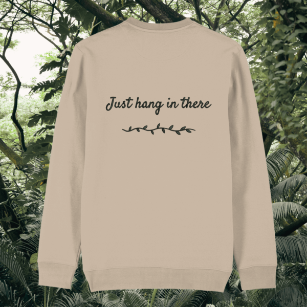 Back of the Desert Dust organic cotton sweater featuring sloth illustration and the phrase “Just Hang In There” – Mindful Earth UK sustainable fashion