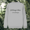 Back of the Heather Grey organic cotton sweater featuring sloth illustration and the phrase “Just Hang In There” – Mindful Earth UK sustainable fashion