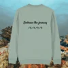 Back of the aloe green organic cotton sweater featuring turtle illustration and the phrase “Embrace the Journey” – Mindful Earth UK sustainable fashion