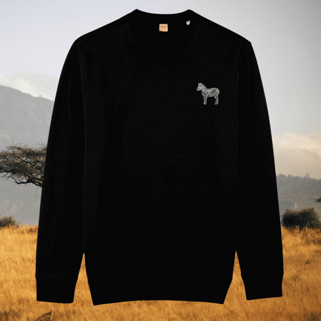 Black organic cotton sweater with zebra print design and motivational “Dare to Be Different” message on the front – Mindful Earth sustainable UK clothing